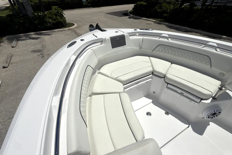 Slide: The Image of 2023 Bertram 28 CC boat with spacious white seating area and modern design. - 30