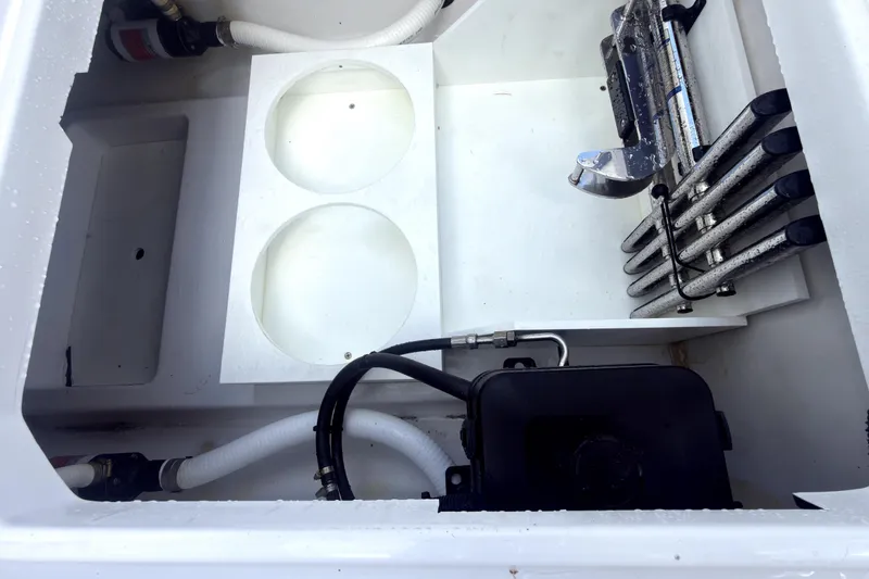 Slide: The Image of Interior view of 2023 Bertram 28 CC boat compartment with hoses and equipment. - 31
