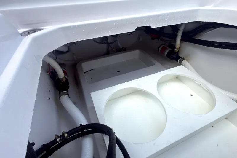 Slide: The Image of Interior view of 2023 Bertram 28 CC boat showing storage and plumbing components. - 32