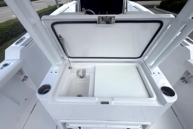 Slide: The Image of 2023 Bertram 28 CC boat with open storage compartment and cup holders. - 36