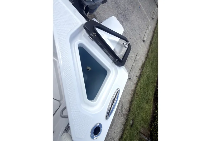 Slide: The Image of 2023 Bertram 28 CC boat detail showing storage compartment and handle. - 37