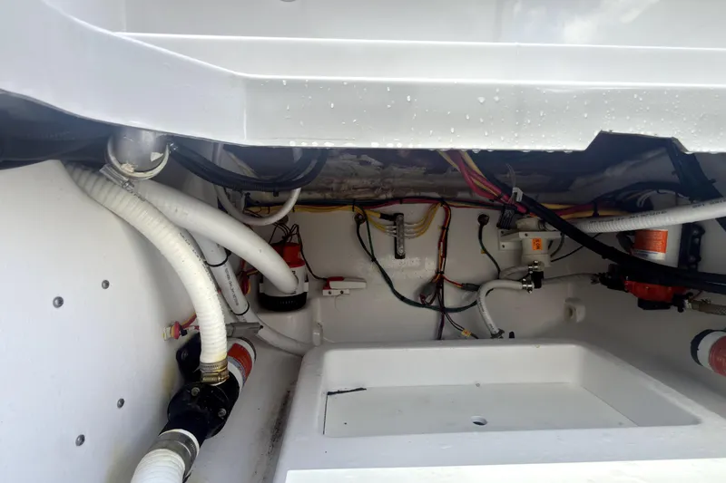 Slide: The Image of 2023 Bertram 28 CC boat interior showing wiring and plumbing components. - 6