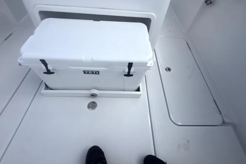 Slide: The Image of 2023 Bertram 28 CC boat deck with Yeti cooler storage. - 7