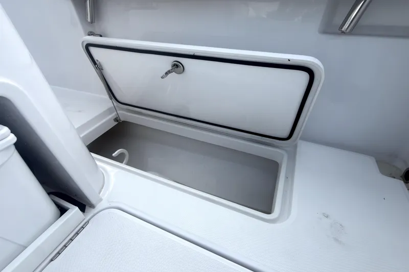 Slide: The Image of Storage compartment on a 2023 Bertram 28 CC boat, featuring a secure latch. - 8
