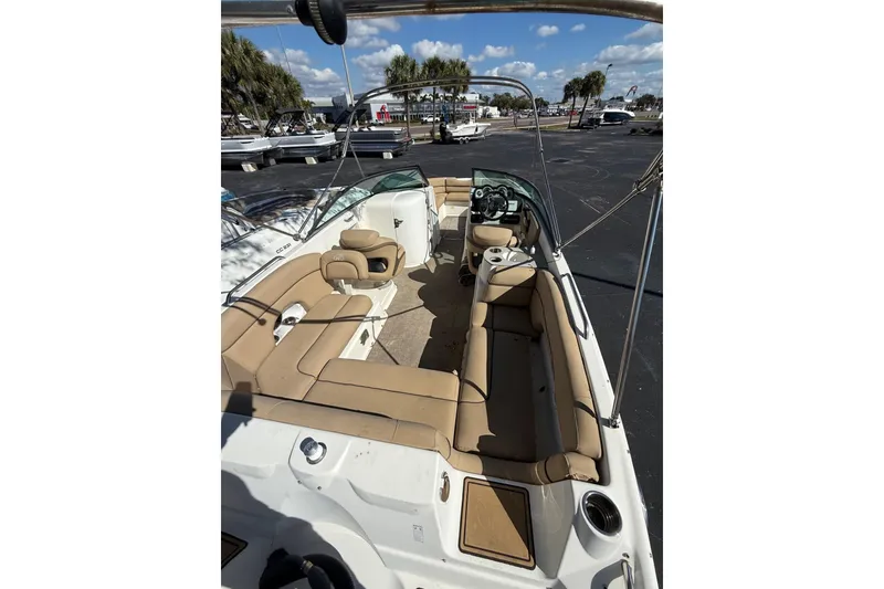 Slide: The Image of 2020 NauticStar 243 DC boat with spacious tan seating and sleek design. - 3