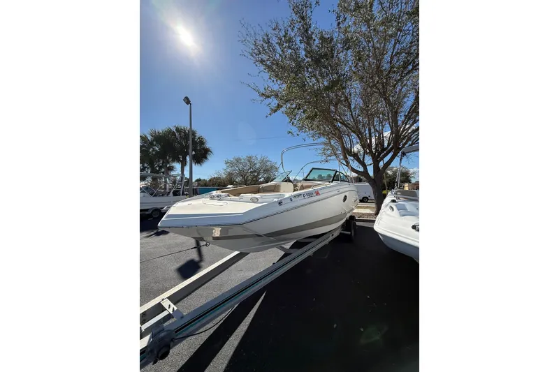 Slide: The Image of 2020 NauticStar 243 DC boat on trailer under clear blue sky. - 5