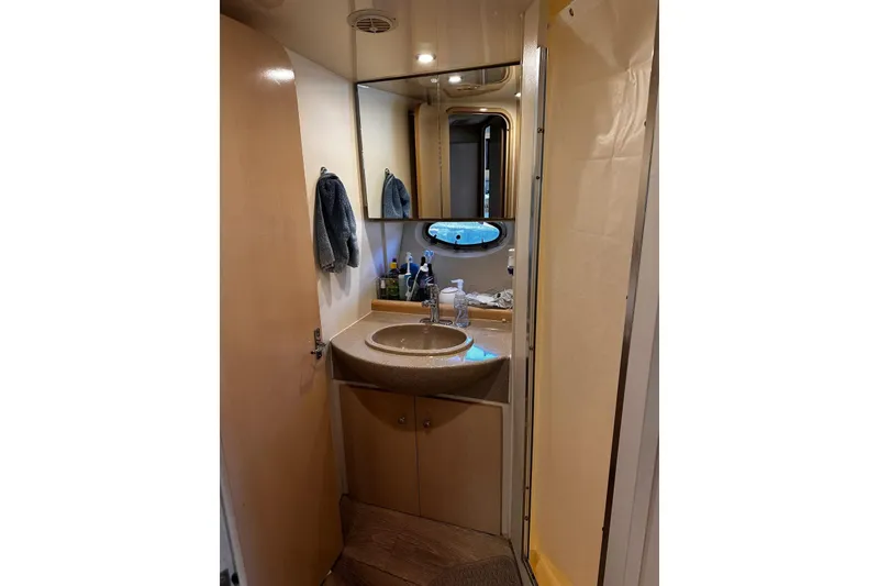 Slide: The Image of 1998 Carver 350 Mariner bathroom with sink, mirror, and toiletries. - 13