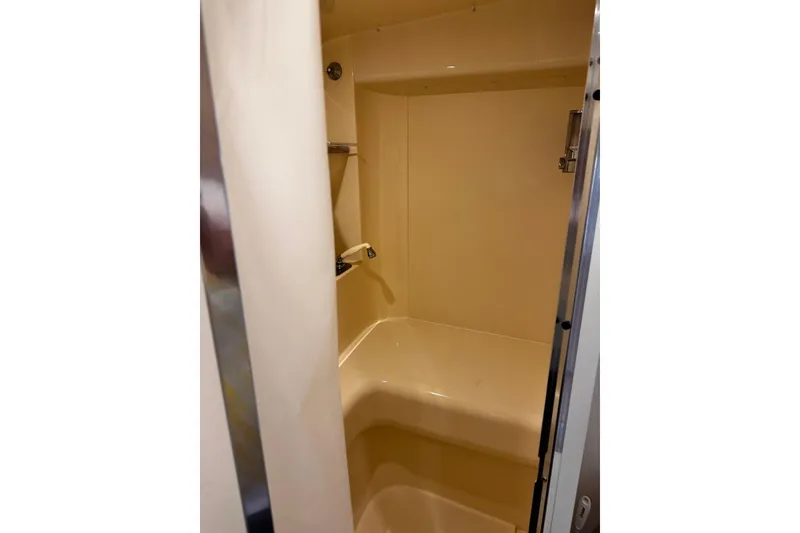 Slide: The Image of Shower area inside a 1998 Carver 350 Mariner yacht, featuring beige interior. - 15