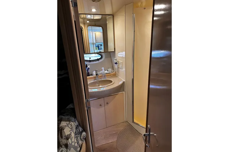 Slide: The Image of 1998 Carver 350 Mariner bathroom with sink, mirror, and porthole window. - 16