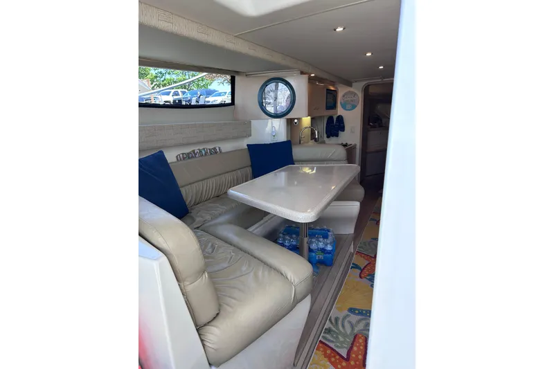 Slide: The Image of Interior of 1998 Carver 350 Mariner yacht with beige seating and dining area. - 19