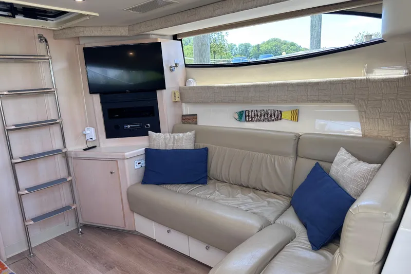 Slide: The Image of Interior of 1998 Carver 350 Mariner yacht with sofa, TV, and ladder. - 20