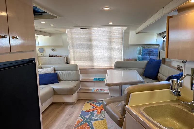 Slide: The Image of Interior of a 1998 Carver 350 Mariner yacht with cozy seating and modern amenities. - 21