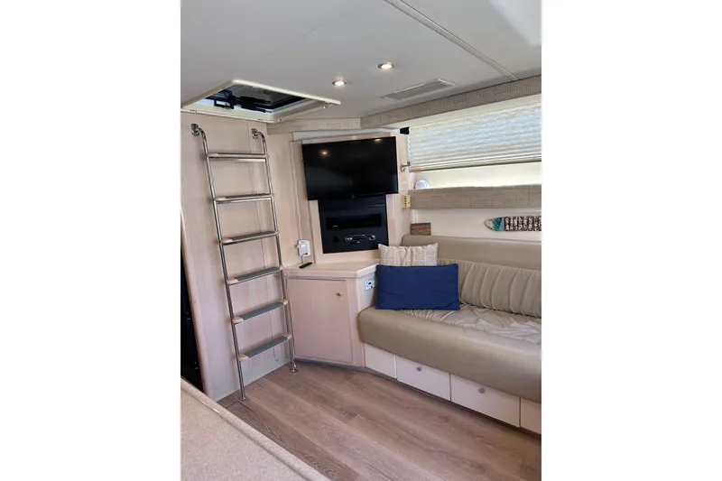 Slide: The Image of Interior of 1998 Carver 350 Mariner yacht with ladder, seating, and TV. - 23