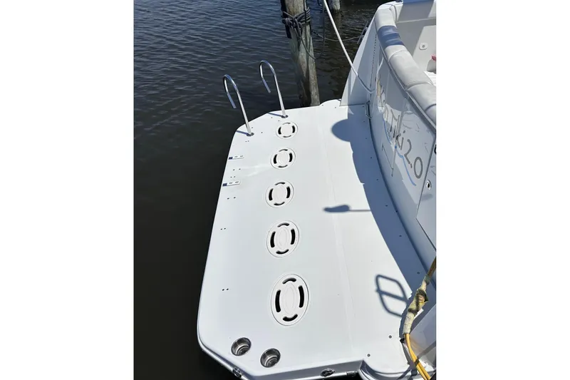 Slide: The Image of 1998 Carver 350 Mariner swim platform with ladder, docked on calm water. - 5
