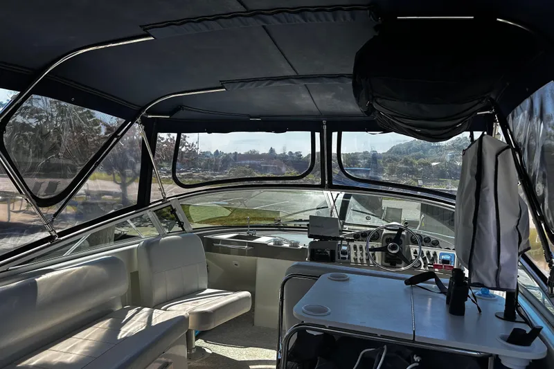 Slide: The Image of Interior view of a 1998 Carver 350 Mariner yacht with helm and seating area. - 9