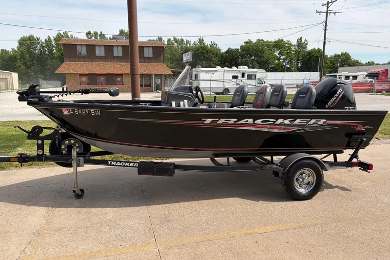 The Image of 2020 Tracker Pro Deep V-16 Single Console boat on trailer, parked outdoors. - 0