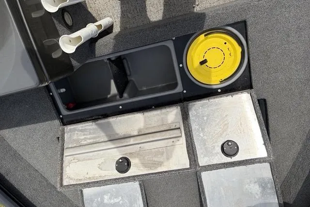 Slide: The Image of 2020 Tracker Pro Deep V-16 boat interior with storage compartments and rod holders. - 10