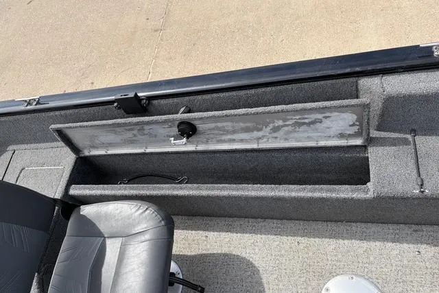 Slide: The Image of 2020 Tracker Pro Deep V-16 boat interior with storage compartment and seat. - 11