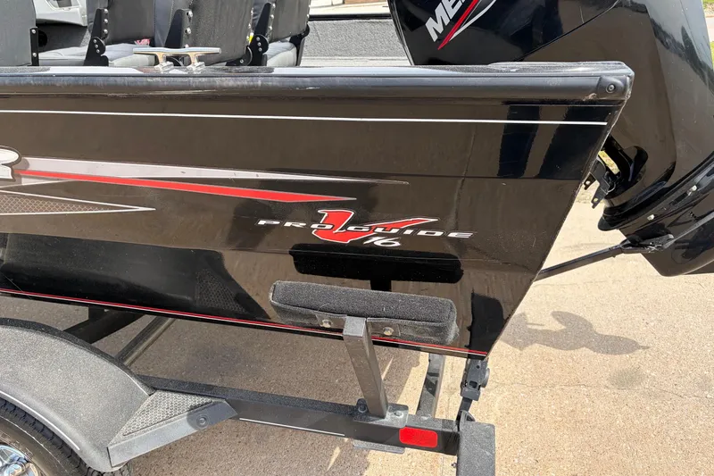 Slide: The Image of 2020 Tracker Pro Deep V-16 Single Console boat on trailer, side view. - 13