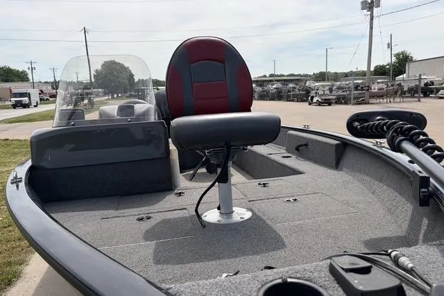 Slide: The Image of 2020 Tracker Pro Deep V-16 Single Console boat with red and black seating, docked outdoors. - 18