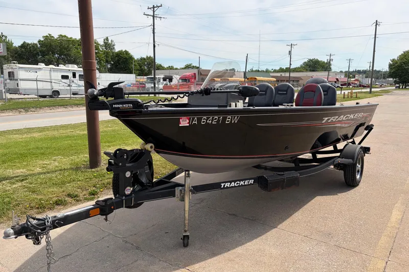 Slide: The Image of 2020 Tracker Pro Deep V-16 Single Console boat on trailer, parked outdoors. - 2