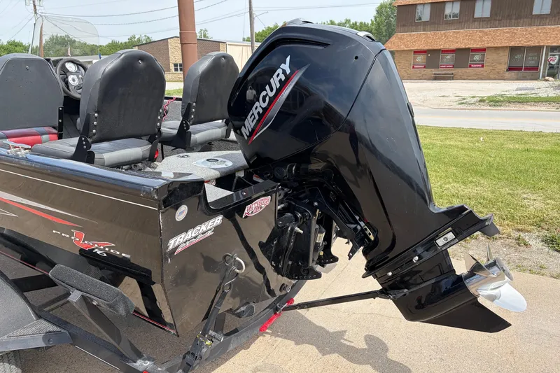 Slide: The Image of 2020 Tracker Pro Deep V-16 boat with Mercury outboard motor, parked outdoors. - 3
