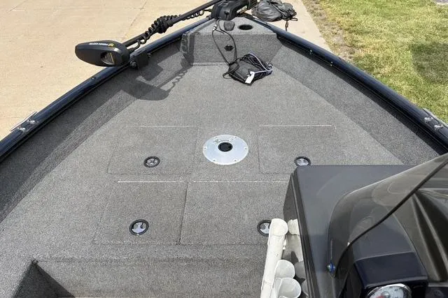 Slide: The Image of 2020 Tracker Pro Deep V-16 boat deck with trolling motor and storage compartments. - 8