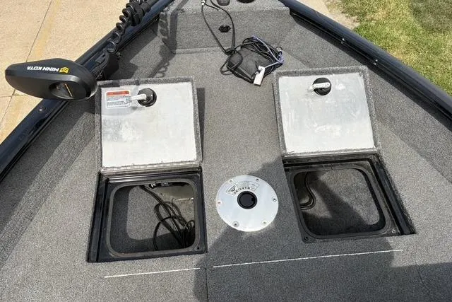 Slide: The Image of 2020 Tracker Pro Deep V-16 boat deck with storage compartments and trolling motor. - 9