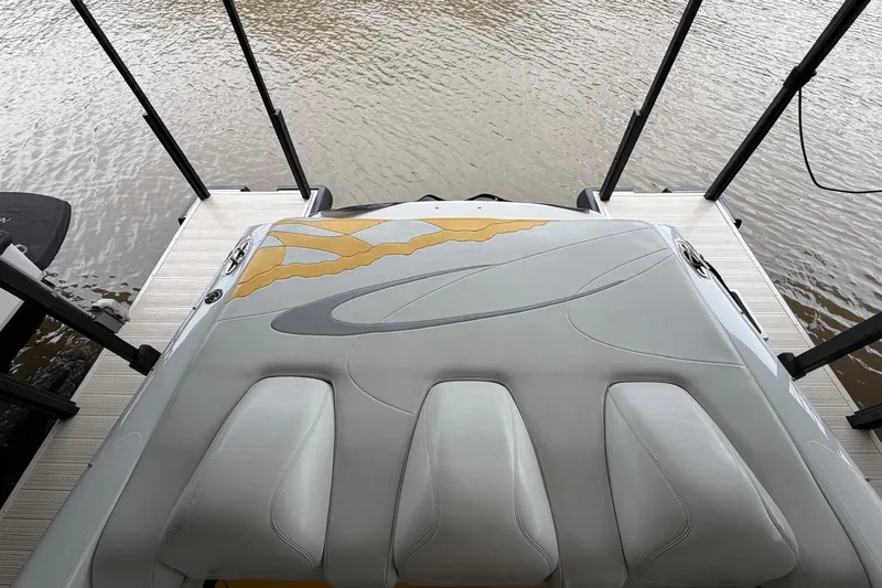 Slide: The Image of 2001 Baja 33 Outlaw boat docked, showcasing sleek design and comfortable seating. - 13