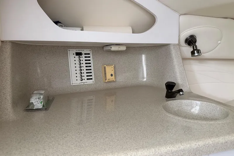 Slide: The Image of 2001 Baja 33 Outlaw boat interior with control panel and sink. - 15