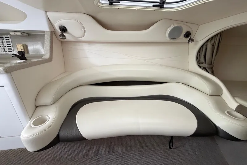 Slide: The Image of Interior seating of a 2001 Baja 33 Outlaw boat, featuring white and black upholstery. - 16