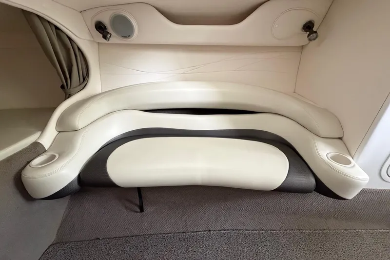 Slide: The Image of Interior seating of a 2001 Baja 33 Outlaw boat, featuring white and black upholstery. - 17