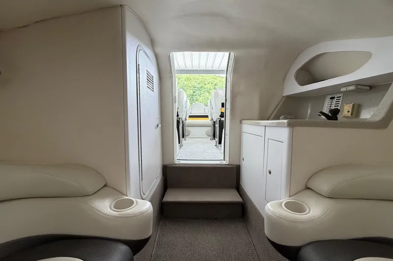 Slide: The Image of Interior of a 2001 Baja 33 Outlaw boat, featuring seating and storage. - 19