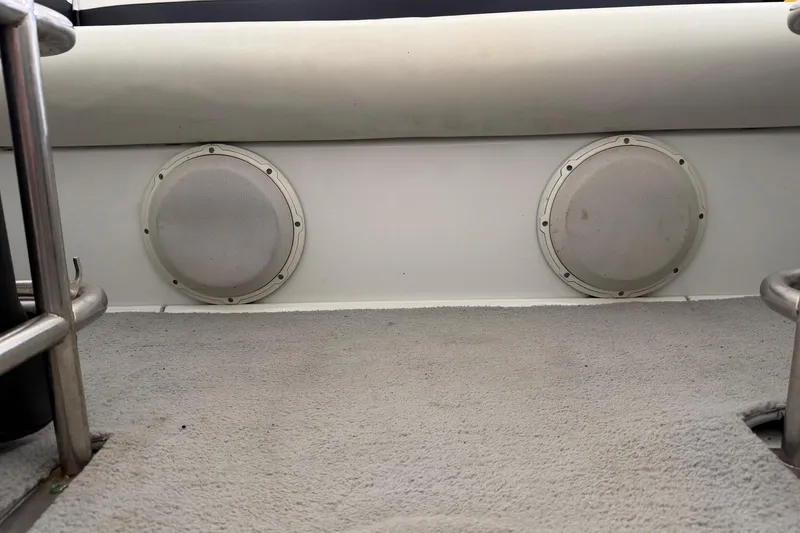 Slide: The Image of Interior of 2001 Baja 33 Outlaw boat with dual speakers and carpeted flooring. - 21