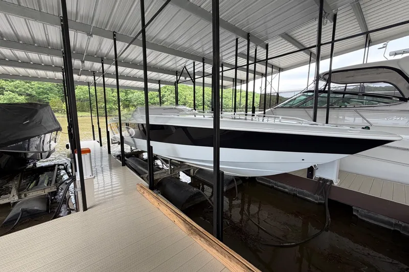 Slide: The Image of 2001 Baja 33 Outlaw boat docked under covered marina. - 22