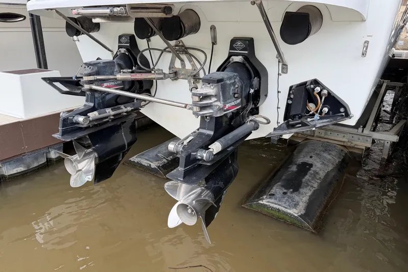 Slide: The Image of 2001 Baja 33 Outlaw boat with dual Mercury outboard engines in water. - 23