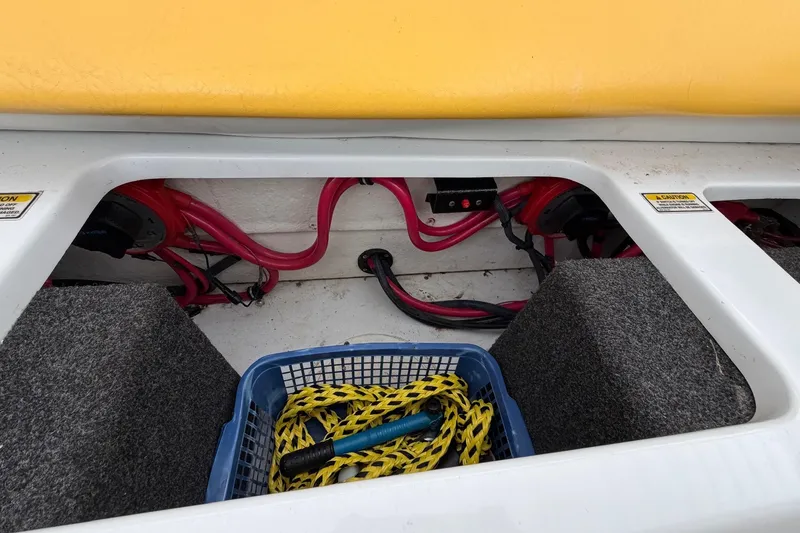 Slide: The Image of 2001 Baja 33 Outlaw boat storage compartment with ropes and wiring. - 24