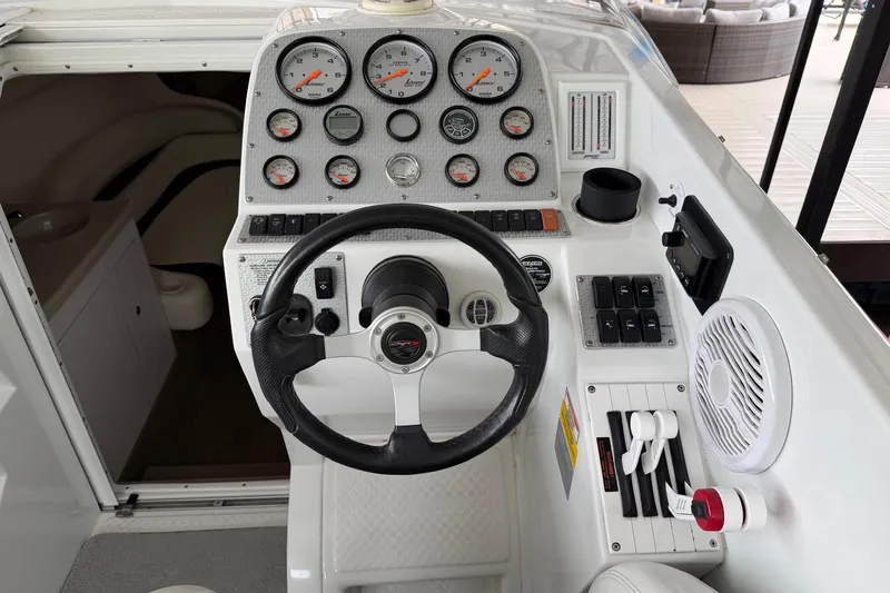 Slide: The Image of Cockpit of a 2001 Baja 33 Outlaw boat with steering wheel and gauges. - 6