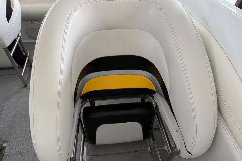 Slide: The Image of White and yellow seating on a 2001 Baja 33 Outlaw boat interior. - 8
