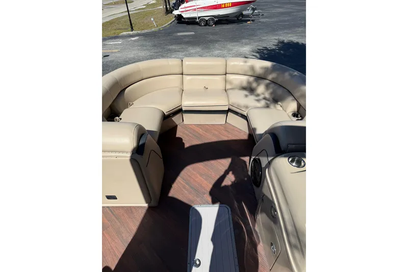 Slide: The Image of 2017 South Bay 523RS boat interior with beige seating and wood flooring. - 12