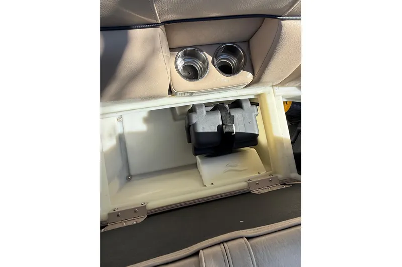 Slide: The Image of 2017 South Bay 523RS storage compartment with cup holders and battery box. - 14