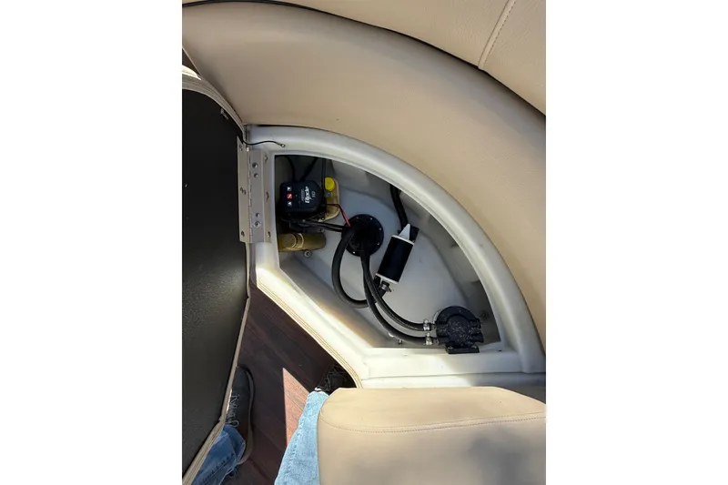 Slide: The Image of 2017 South Bay 523RS boat interior storage compartment with visible wiring and components. - 16