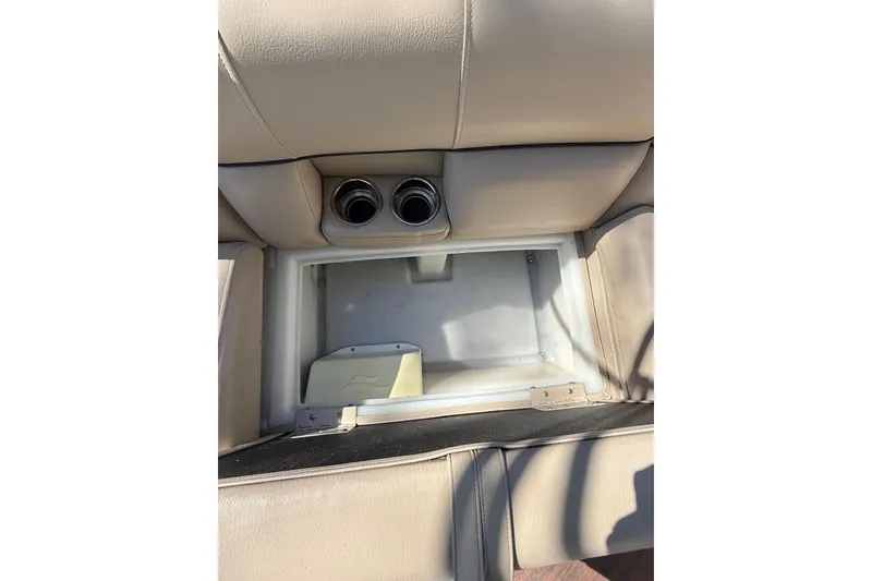 Slide: The Image of 2017 South Bay 523RS boat seat storage compartment with cup holders, beige upholstery. - 17