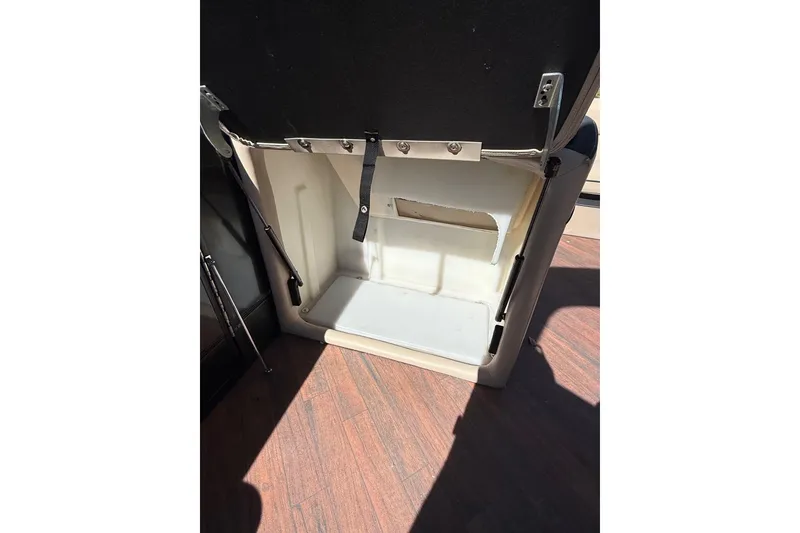 Slide: The Image of Open storage compartment in 2017 South Bay 523RS boat, featuring a sleek interior design. - 20
