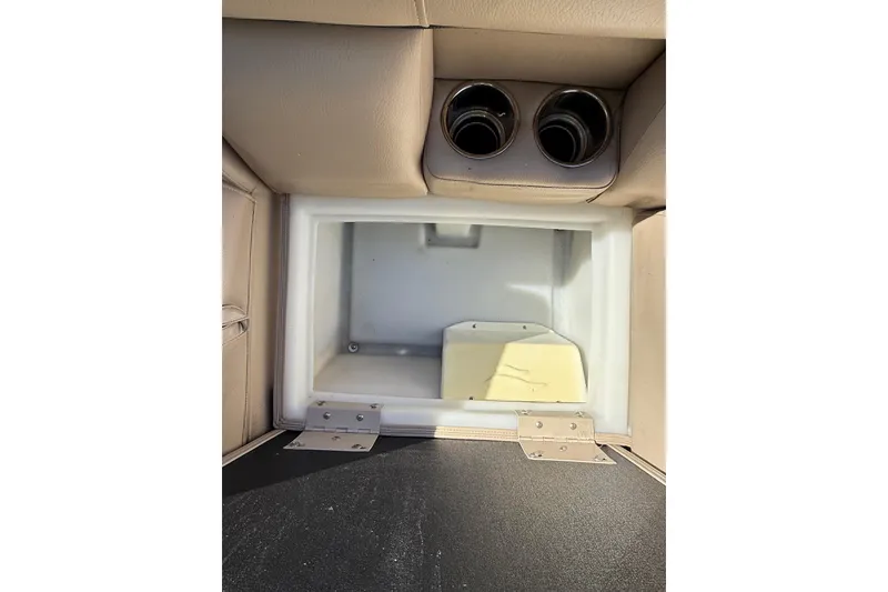 Slide: The Image of Interior storage compartment of a 2017 South Bay 523RS boat with cup holders. - 8