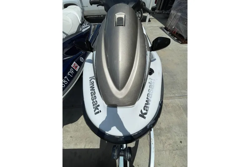 Slide: The Image of 2010 Kawasaki Jet Ski STX-15F, top view, parked on concrete surface. - 3