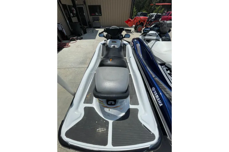 Slide: The Image of 2010 Kawasaki Jet Ski STX-15F parked beside a Yamaha watercraft. - 4