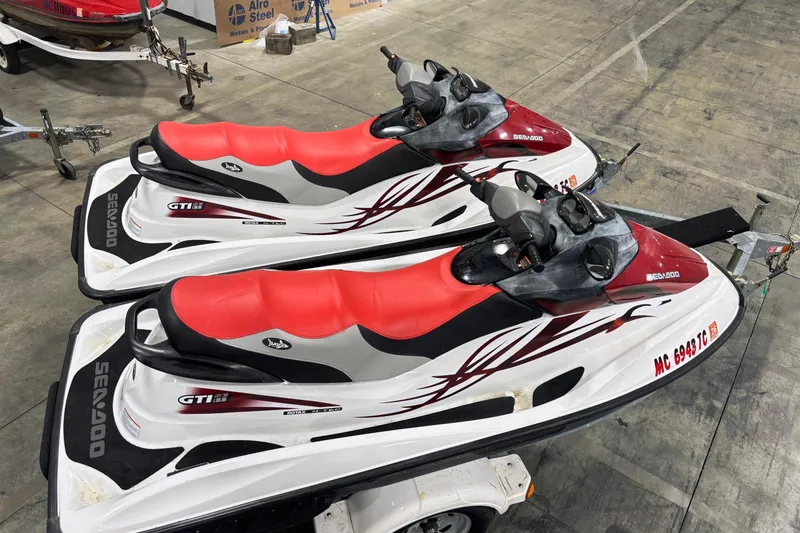 Slide: The Image of Two 2008 Seadoo GTI SE 155 jet skis with red seats on a trailer. - 8