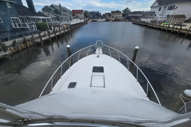 Slide: The Image of 2003 Henriques 35 Sportfisherman docked in a scenic residential canal. - 10