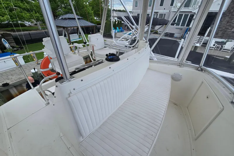 Slide: The Image of 2003 Henriques 35 Sportfisherman boat interior with white seating and helm station. - 12